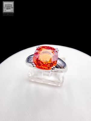 an orange ring sitting on top of a white table