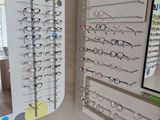 many glasses on display in a store with a mirror