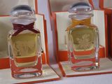 three bottles of perfume sitting on display in a box