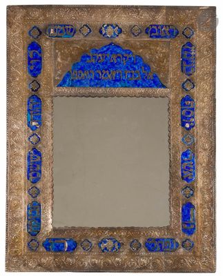 a blue glass mirror with a gold frame and a decorative design