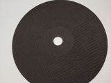 a close up of a black disc on a white surface