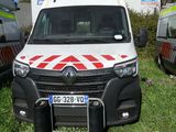 three ambulances parked in a grassy field next to each other