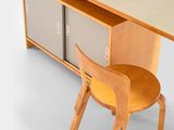 a desk with a chair and a cabinet on it