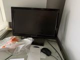 a computer monitor sitting on top of a desk next to a window