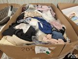 a cardboard box filled with clothes and other items