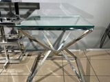 a glass table with a glass top on a tiled floor