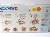 a box of geometric toys on a white surface
