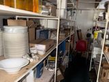 many plates and bowls on the shelves in the room