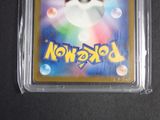 a close up of a pokemon trading card in a plastic case