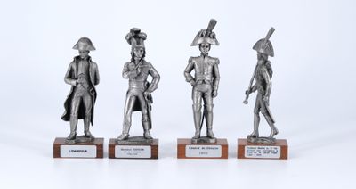 three silver metal figurines of men with hats and tails on wooden bases