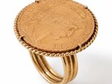 a close up of a ring with a coin on top of it