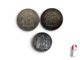 three different types of coins are shown on a white surface
