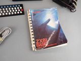 a book sitting on a desk next to a keyboard and a mouse