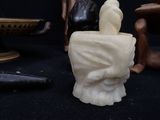 some figurines are sitting on a table with a black background