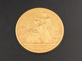 une image représentant une pièce d'or sur laquelle figurent une femme et un homme