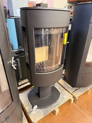 two stoves sitting on pallets in a store