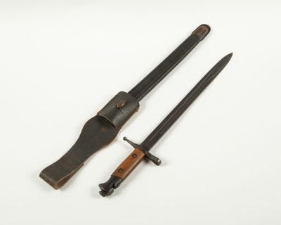 an old knife and a knife holder on a white surface