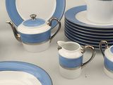 a table with a lot of blue and white plates and cups
