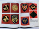 an open book with a picture of a bunch of badges on it