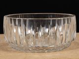 a glass bowl sitting on a table with a black background
