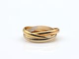 a close up of a gold ring on a white surface