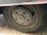 a close up of a flat tire on a car