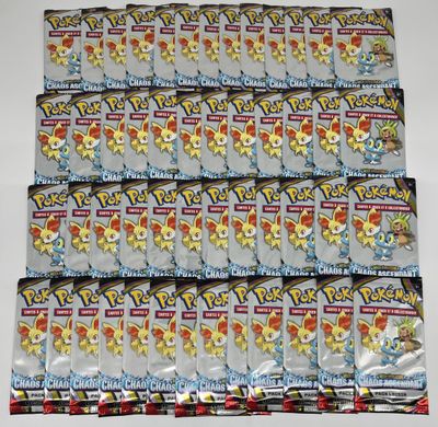 a pile of pokemon trading cards sitting on top of each other