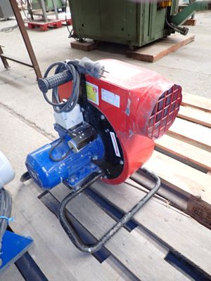 a red and blue machine that is sitting on a pallet