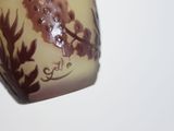 a vase that has a brown and white design on it
