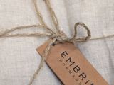 an image of a package of linens wrapped in twine and tied with twine