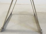 a glass table with a metal frame on top of it