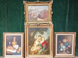 three framed pictures of a couple of paintings on a table