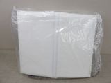 a white napkin wrapped in plastic on top of a table