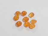 a close up of a group of orange gems on a white surface