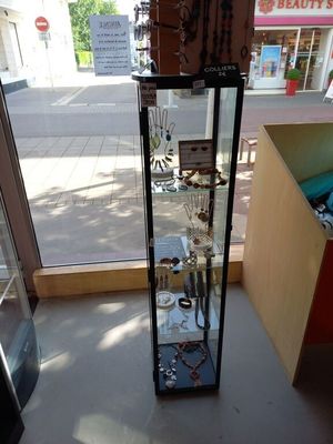 a glass display case in the corner of a store