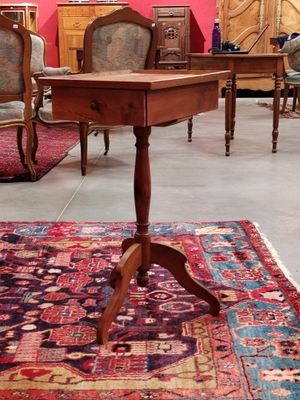 a rug on the floor in a room with chairs and a table