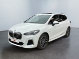 a white bmw x2 is parked in a white room