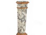 marble pedestal with a wooden base and a carved top
