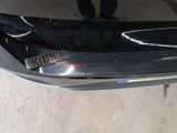 a person standing next to a car that has been dented