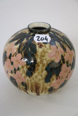 a small vase with a number on it sitting on a table