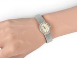 an image of a woman ' s wrist with a watch on it