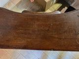 a wooden bench with a wooden seat on the floor