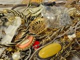 a pile of gold and silver jewelry on a table