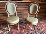 two chairs sitting next to each other on a rug