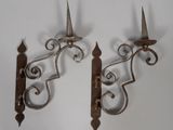 pair of antique wrought iron sconces on a white background