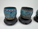 three blue and gold vases sitting on top of a black stand
