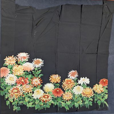 an image of a piece of cloth with flowers and leaves on it