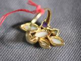 a gold ring with a white flower on top of it