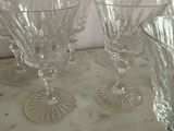 four wine glasses sitting on a marble counter top
