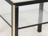 a black and gold coffee table with a glass top